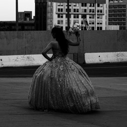 A girl in black and white posing for her Quinceanera celebration by Dana Lance for Danajohn Photography © danajohn302